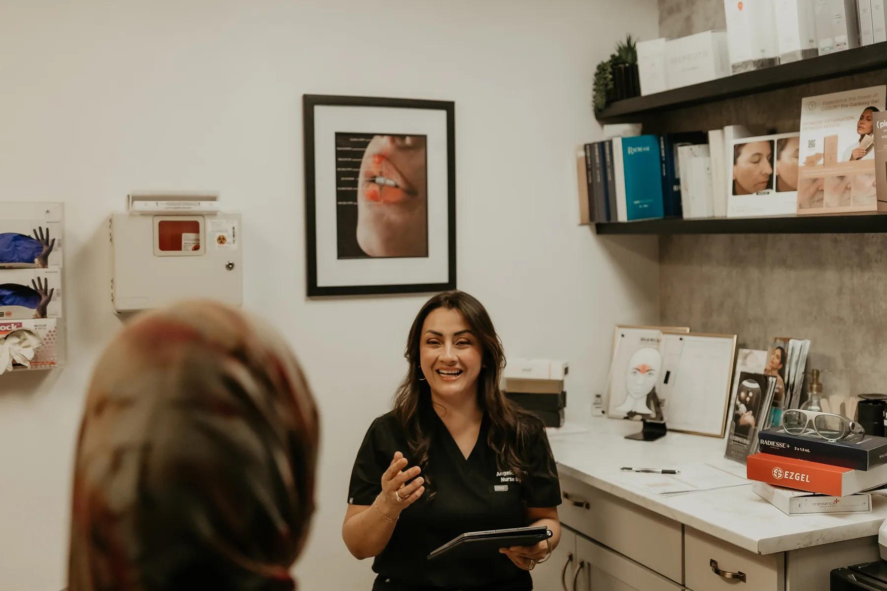 Angelica Alcaraz, BSN, RN, talking a client through a treatment plan at Revive Beauty Bar in Salinas