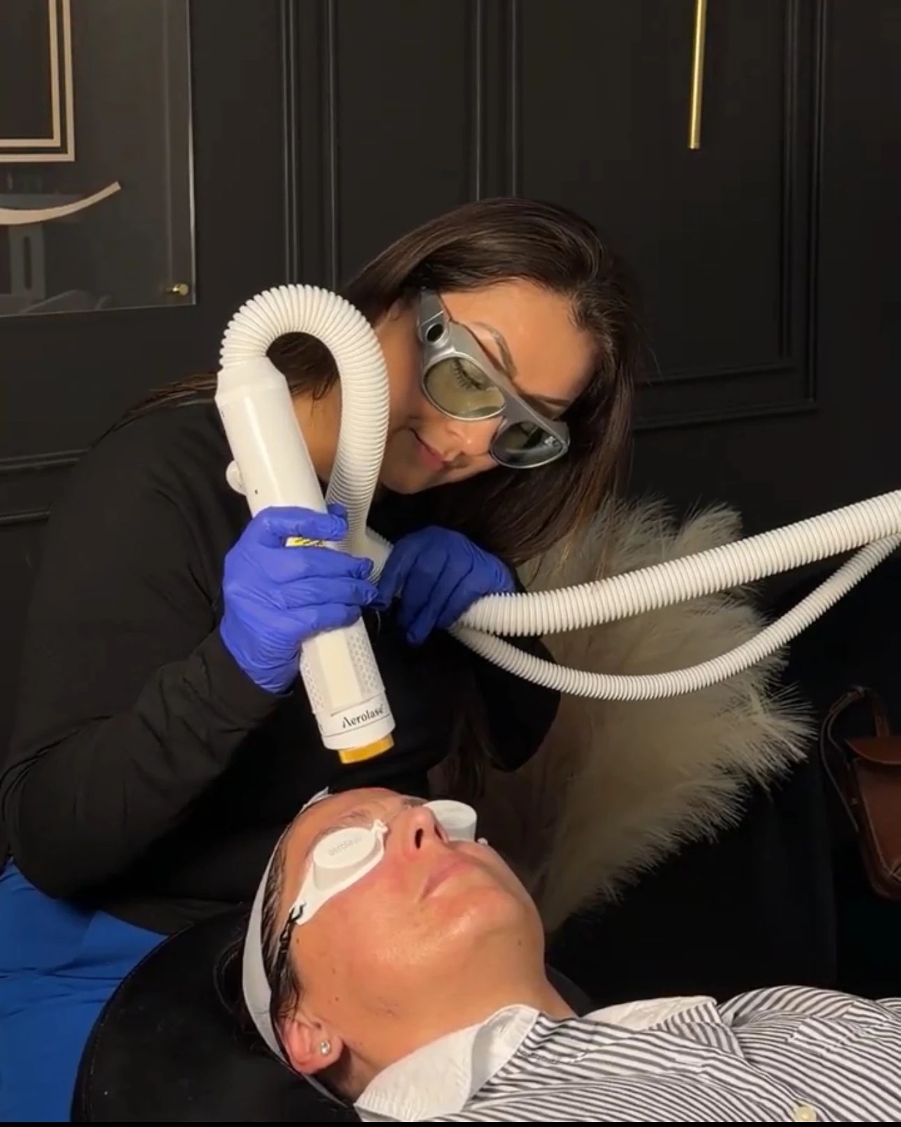 Angelica Alcaraz, BSN, RN, treating a patient with the Aerolase Neo Elite laser at Revive Beauty Bar in Salinas, CA — both wearing protective eyewear