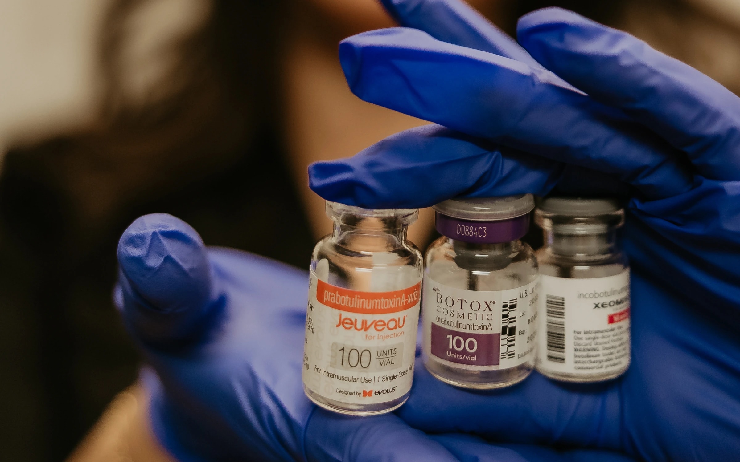 Angelica Alcaraz, BSN, RN, holding Jeuveau, BOTOX Cosmetic and XEOMIN vials at Revive Beauty Bar in Salinas